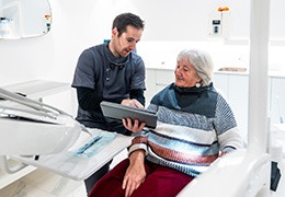 Senior woman conversing with her dentist