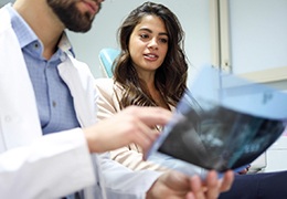 Dentist and patient reviewing X-ray together