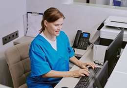 Dental team member working on computer