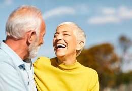 Healthy seniors enjoying the benefits of dental implants