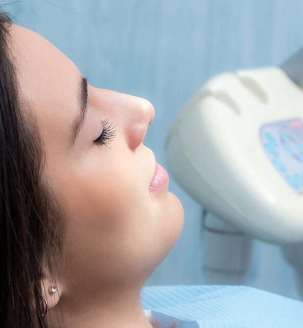 Woman with eyes closed in dental chair