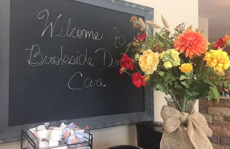Welcome to Brookside Dental Care sign and flowers