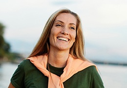 Portrait of happy, smiling woman standing outdoors