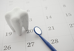 Calendar with tooth model and dental mirror