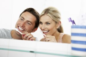 couple brushing teeth