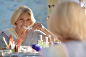 senior woman brushing teeth