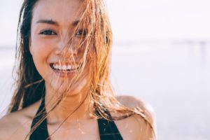 Woman with healthy gums enjoying the summer sun