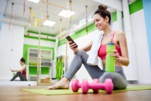 Smiling woman thinking about fitness and oral health after a workout