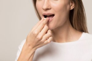 Woman preparing to swallow sedative medication