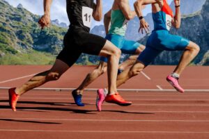 Group of athletes running on track