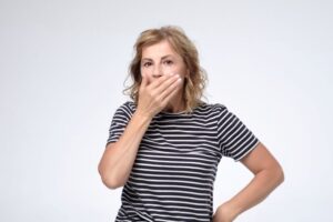 Concerned woman covering her mouth 